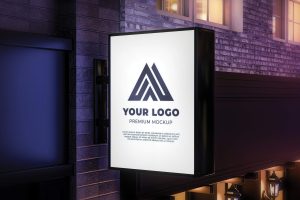 Backlit projecting shop sign on exterior wall, example of outdoor signage visibility